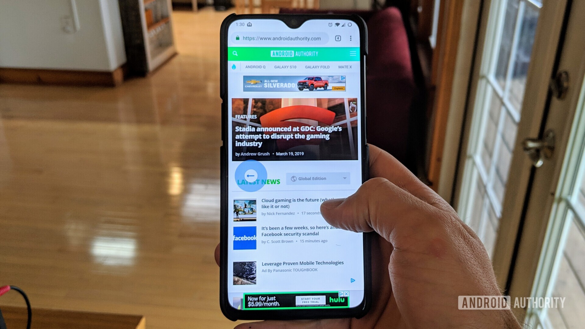 Ein Foto einer Hand, die ein Smartphone hält, das die neuen Chrome-Gesten zum Navigieren durch Webseiten demonstriert.